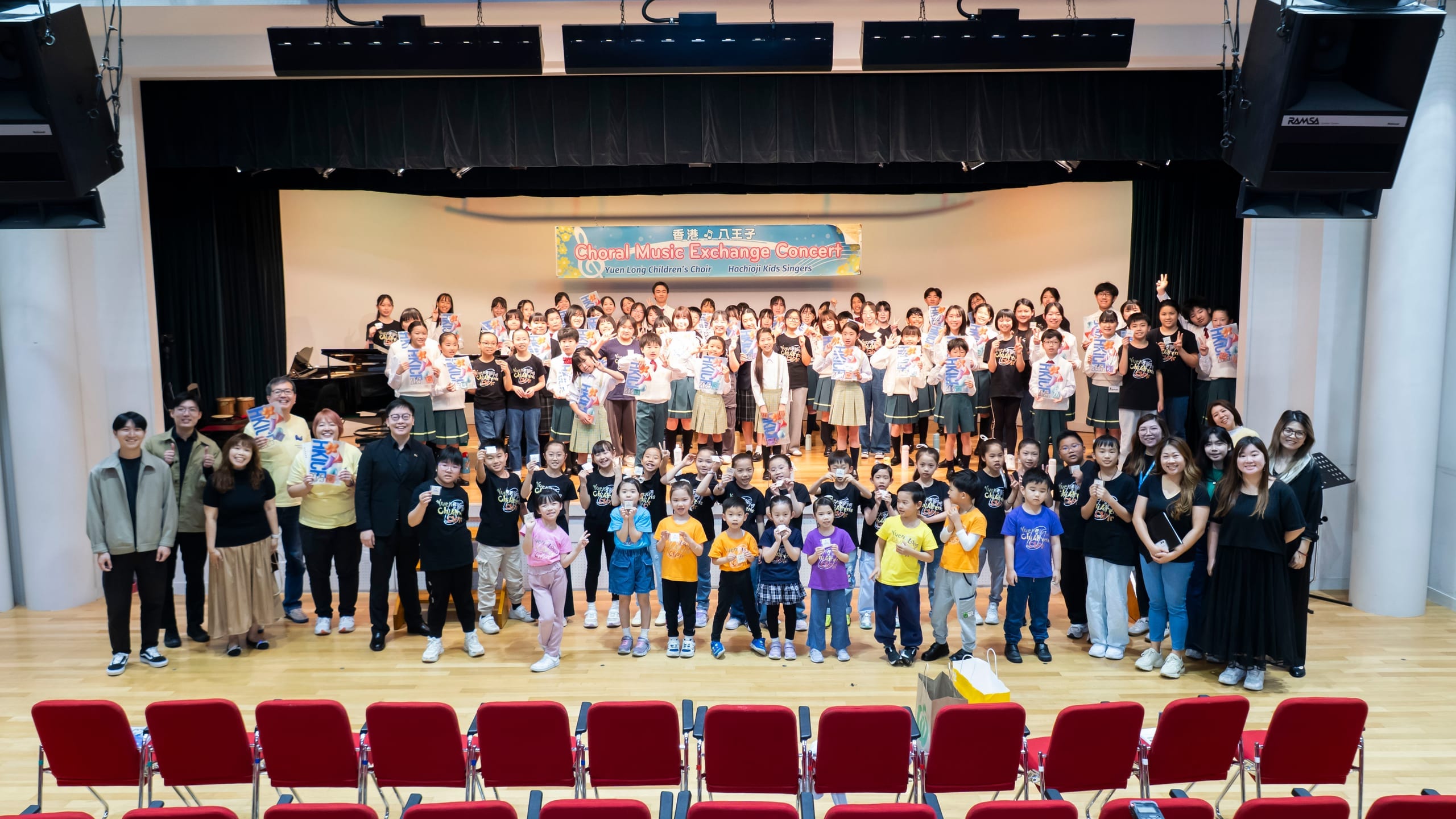 Yuen Long Children's Choir and Hachioji Kids Singer with their conductors and families on stage at the Choral Music Exchange Concert in Hachioji, Japan